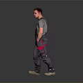 Male Worker In Gray Overalls With Red Pockets Standing On Gray Background