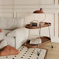 Two Tier Wooden Side Table with Wheels Lamp Alarm Clock Next to Sofa
