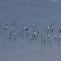 Many People Gathering In Open Area With Different Colored Clothing And Spacious Ground