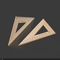 Two Stainless Steel Triangular Rulers With Measurement Scales On Dark Surface