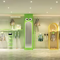 Kids Clothing Store Interior With Green Cartoon Mirror Yellow Display Racks And Hanging Clothes