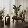Patterned Accent Chair With Side Table Potted Plants And Coffee Cup In Bright Living Room
