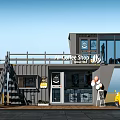 Modern Shipping Container Coffee Shop With Staircase And Outdoor Seating Area