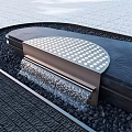 Curved Garden Water Feature With Perforated Top Flowing Water Black Pebbles And Gray Stone Pavement