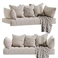 Cozy Neutral Sofa Decor With Multiple Soft Textured Pillows And Knitted Blanket