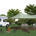 Scenic Garden Landscape With RV Canopy Tent Campfire And Chairs On Green Grass