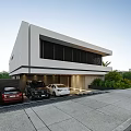 Modern Detached Villa With Garage Parked Cars Palm Trees And Greenery