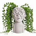 White Human Shaped Vase with White Flowers Green Hanging Vines and Small Round Leaves
