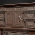 Ornate Vintage Carved Wood Fireplace Featuring Brick Interior And Decorative Columns