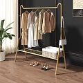 Golden Metal Clothes Rack With Hanging Clothes Woven Basket And Shoes In Home Setting