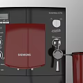 Black DeLonghi Coffee Machine With Red Cup And Fresh Fruit Platter In Kitchen