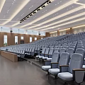 Spacious Conference Room With Large Screen Rows Of Seats And 40th Anniversary Decorative Posters