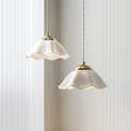 Two White Petal shaped Pendant Lights with Gold Bases in Minimalist Interior Setting