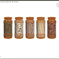 Transparent Glass Spice Jars With Metal Lids Containing Various Ingredients On Black Background