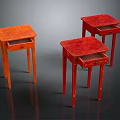Three Orange And Red Side Tables With Drawers And Slender Legs On Dark Reflective Surface