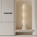 White Sculpture Lamp With Wavy Design On Wooden Shelf Next To Cabinet