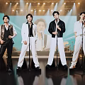 Men Performing Singing On Stage With Microphones And Bright Stage Lights