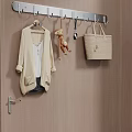 Wall Mounted Hook With Hanging Coat Stuffed Toy Spoon And Handbag On Brown Striped Wall