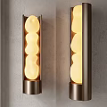 Modern Wall Sconces With Metal Frame And Glowing Irregular Shaped Globes On Gray Wall Interior