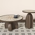 Round Coffee Tables With Patterned Tops And Curved Brown Bases On Geometric Rug