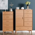 Light Wooden Entryway Cabinet And Side Cabinet With Drawers Books Vases On Blue Wall Artwork