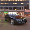 Black Convertible Sports Car Parked On Urban Street With Neon Lights