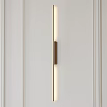 Vertical Metal Wall Lamp with LED Strip Light on White Paneled Wall with Lines