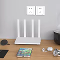 Modern Computer Workspace With Monitor Router Smartphone Wireless Earbuds And Mouse On Wooden Desk