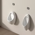 Two Modern White Wall Mounted Urinals in Clean Bathroom Interior Design