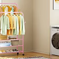 Pink Clothes Rack With Hanging Folded Clothes Baskets And Shoes In Laundry Room