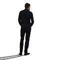 Man In Black Shirt And Dark Pants Standing With Hands In Pockets On White Background