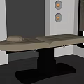 Beige Leather Massage Bed With Pillow On Black Base In Modern Spa Room