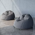 Two Gray Bean Bag Chairs In Modern Interior With Smooth Floor And Wall