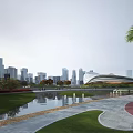Scenic Urban Park Landscape With Water Pond Red Gray Pathway Green Lawn And Trees