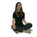 A woman sitting cross-legged in black top black pants and green shoes with long hair