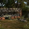 Natural Outdoor Scenery With Camouflage Shelter Sandbags Tires Metal Barrels Trees And Grassland