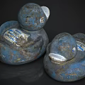 Two Worn Blue Rubber Duck Sculptures With White Label And Textured Details