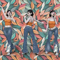 Three Women in Orange Tops and Blue Flared Jeans Posing Against Colorful Leaf Pattern Backdrop