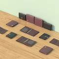 Multiple Various Colored Wallets On Wooden Tabletop With Open And Closed Designs And Metal Clasps