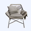 Stylish Rattan Leisure Chair With Metal Legs Gray Cushion Pillow And Draped Blanket