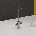 Stainless Steel Faucet On White Countertop With Marble Object And Red Accessory
