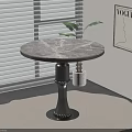 Round Marble Dining Table with Black Pedestal Base near Window Blinds and Vogue Artwork