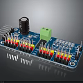Blue Electronic Circuit Board With Black Capacitor Green Connector And Colored Pins