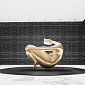 Golden Modern Sculpture With Black Circular Base And Marble Floor In Dark Wall Space