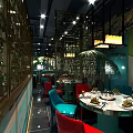 Modern Restaurant Interior With Decorative Walls Pendant Lights Colorful Seating And Dining Tables
