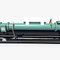 Industrial Chiller Unit with Green Cylindrical Components Control Panel and Black Cylindrical Pipes