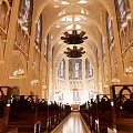 Sacred Church Interior With Stained Glass Window Arched Structures And Memorial Walls
