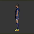 Man in Blue Soccer Jersey and Blue Shorts Standing on Gray Background with Yellow Shoes
