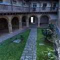Historic Building Courtyard With Arched Arcades Stone Columns Flagstone Path Lawn And Green Plants