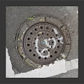 Manhole Cover On Cracked Road Surface Slab With Metal Grid And Holes